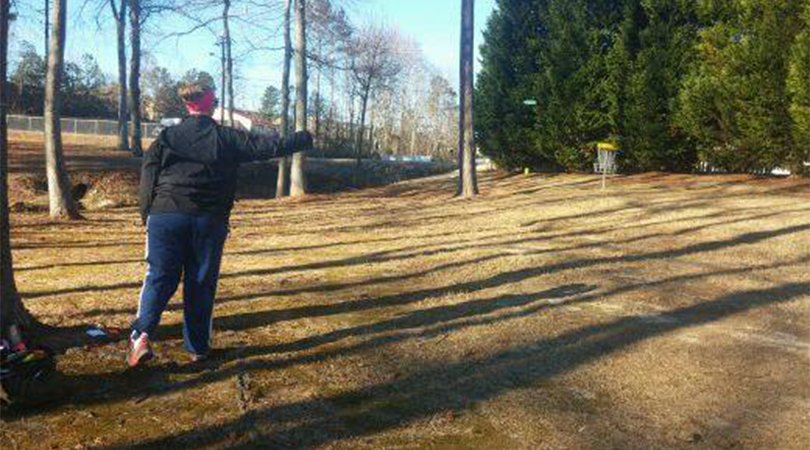 Person throwing a disc golf frisbee