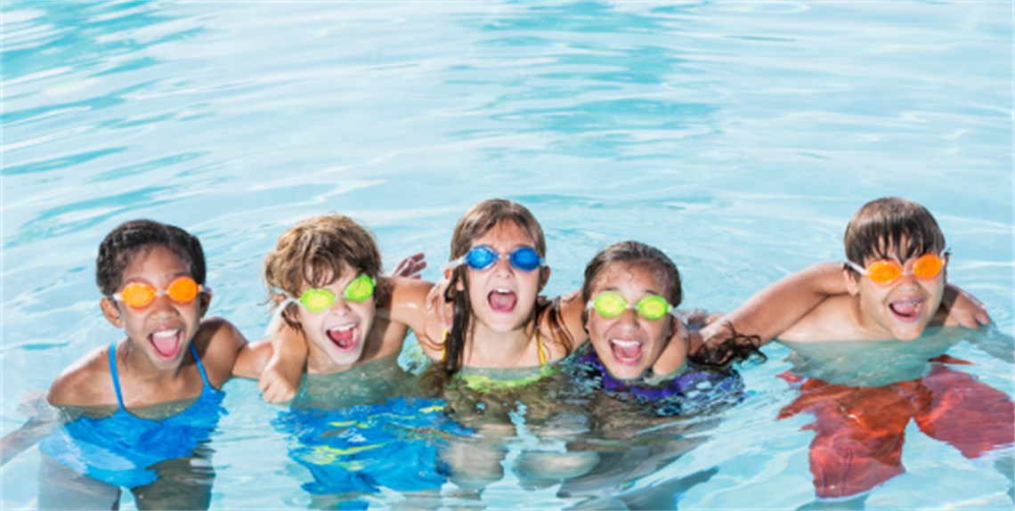 Five kids in pool with swim goggles on