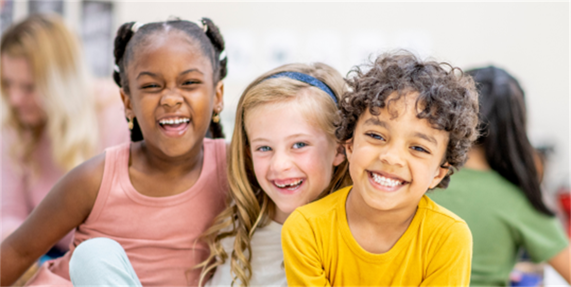 2 girls and a boy smiling for a photo