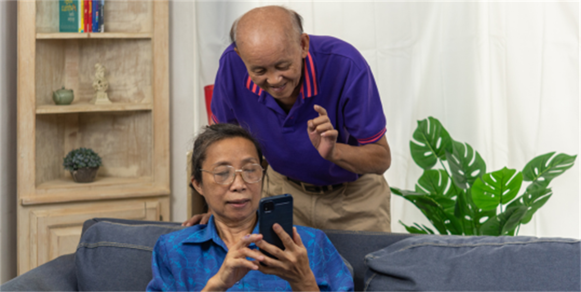 Senior Asian Couple looking at smart phone
