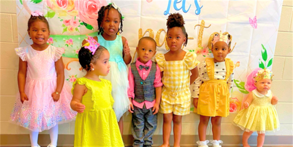 Young ladies and a gentlemen all dressed up for tea