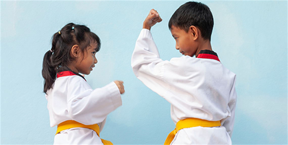 Asian boy and girl practicing Taekwondo