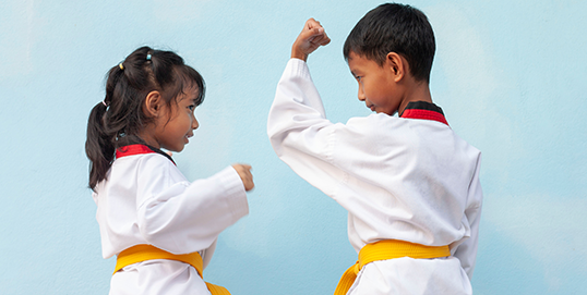 Asian boy and girl practicing Taekwondo