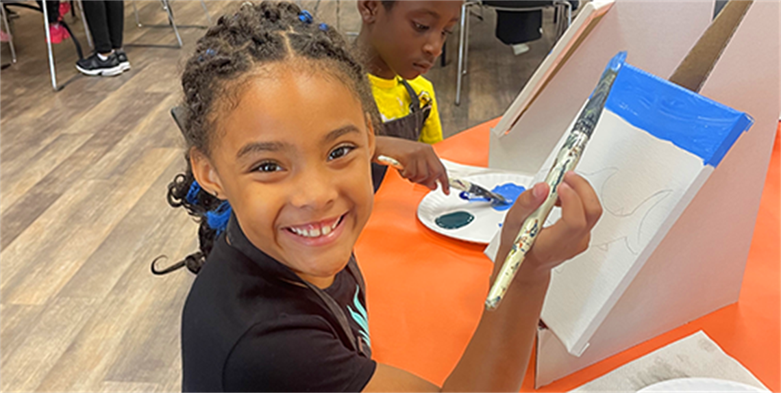 Smiling girl painting