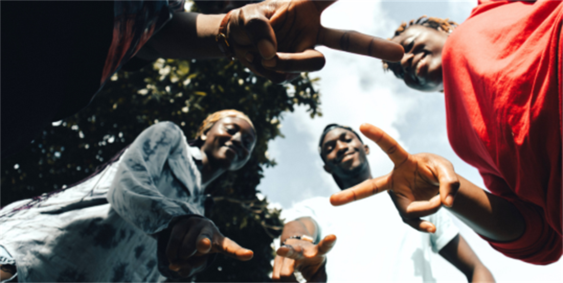 Group of teens in a circle from below looking up