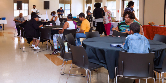Various families sitting at tables and talking