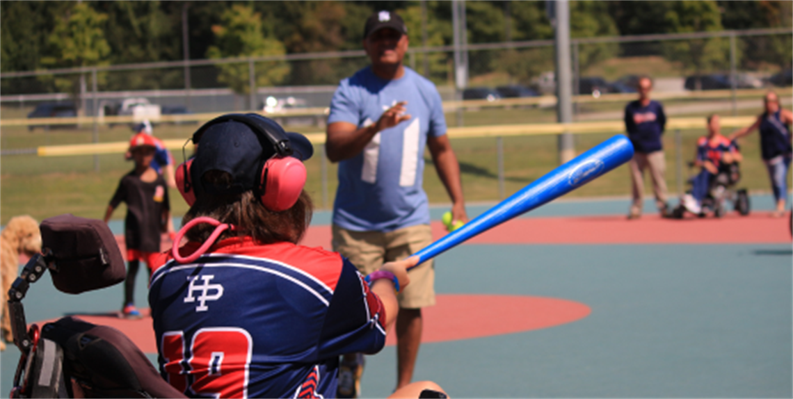 Batter in Wheelchair swings at a pitch 